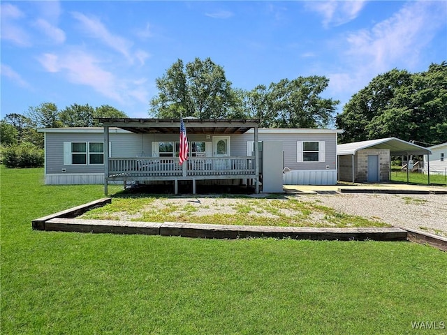 234 Broad Leaf Cir, Moundville, AL 35474 - rear view of house featuring a lawn, a wooden deck, a shed, an outdoor structure, and driveway
