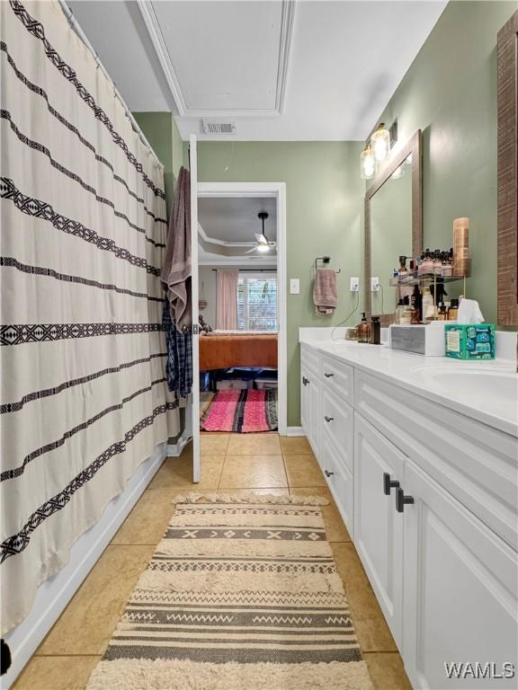 bathroom with ceiling fan, vanity, crown molding, and tile patterned flooring