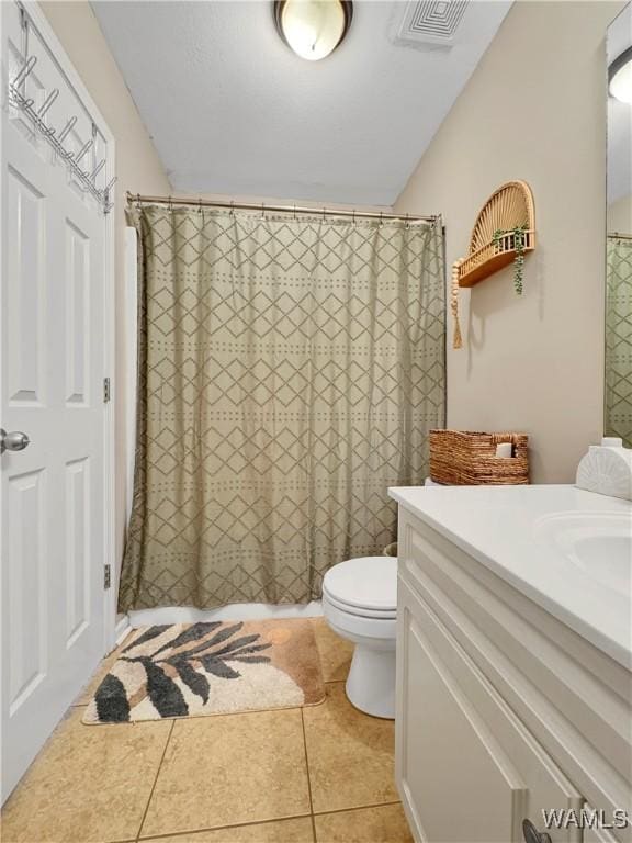 bathroom with toilet, a shower with curtain, tile patterned floors, and vanity