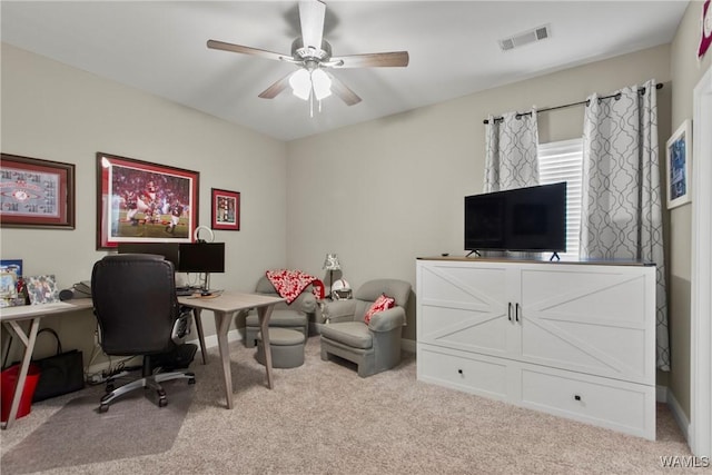 office space featuring ceiling fan and light carpet