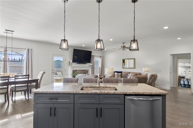 kitchen with sink, plenty of natural light, pendant lighting, and stainless steel dishwasher