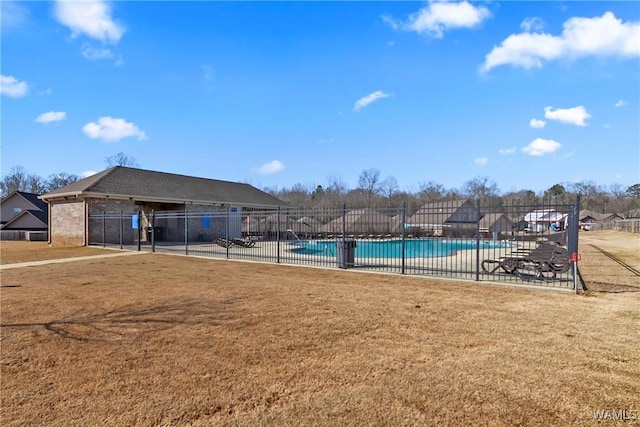 view of pool with a lawn