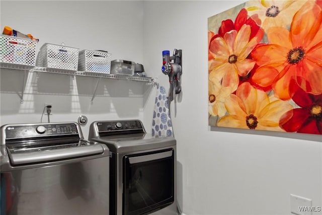 laundry room featuring washing machine and clothes dryer