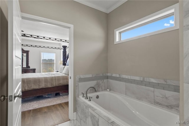 bathroom featuring a healthy amount of sunlight, crown molding, a relaxing tiled tub, and hardwood / wood-style floors