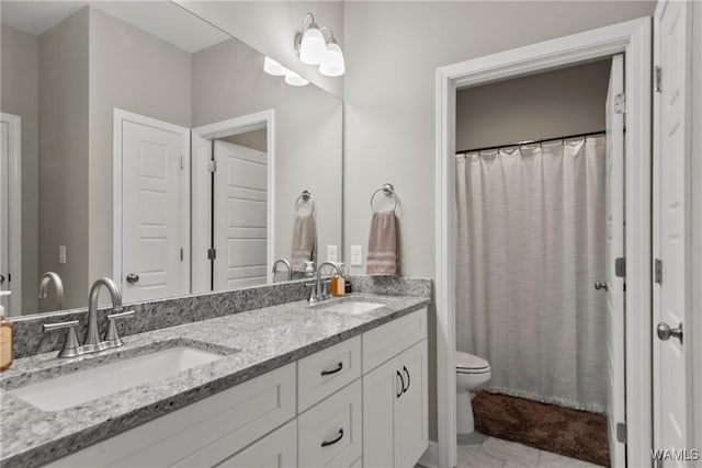 bathroom with toilet, tile patterned flooring, and vanity