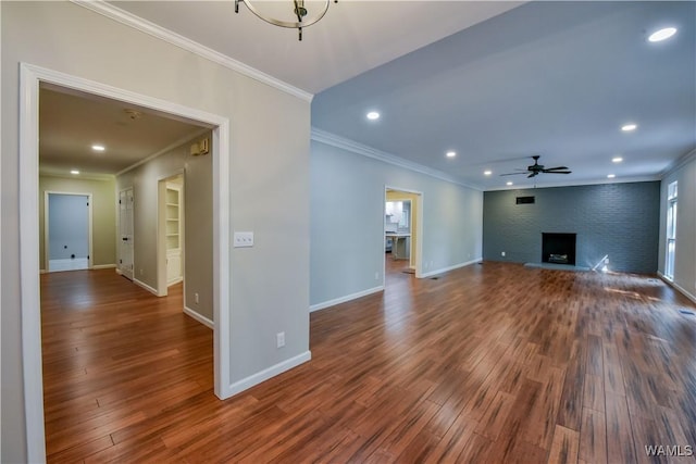 unfurnished living room featuring baseboards, dark wood finished floors, a ceiling fan, and crown molding