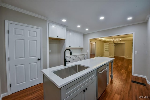 kitchen with ornamental molding, dishwasher, white cabinetry, and a sink