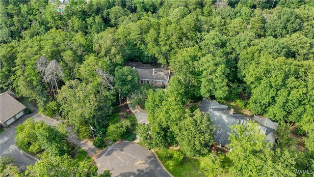 drone / aerial view with a wooded view