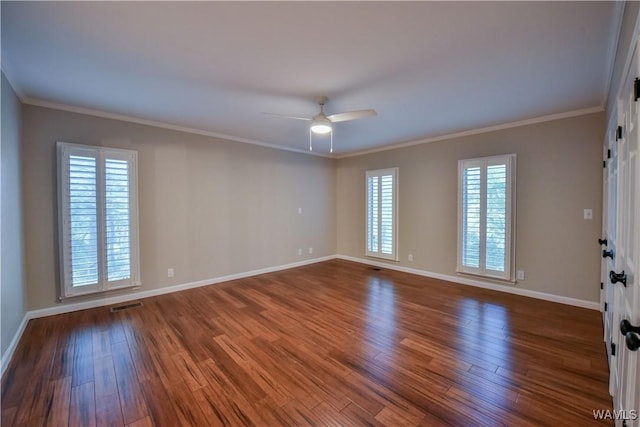 spare room featuring visible vents, ornamental molding, a ceiling fan, and wood finished floors