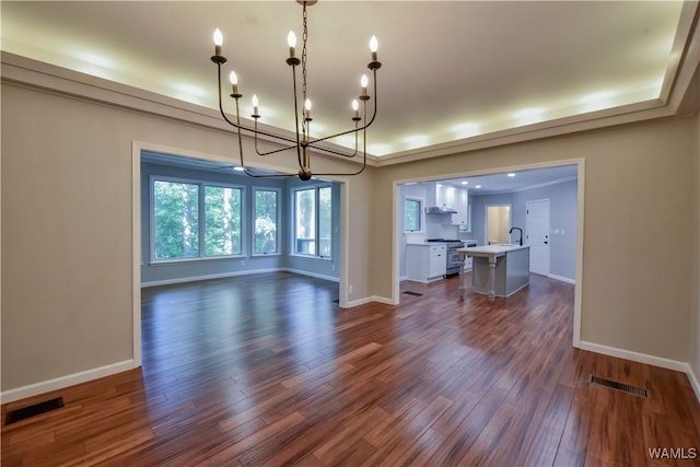 unfurnished dining area featuring dark wood finished floors, visible vents, and a chandelier