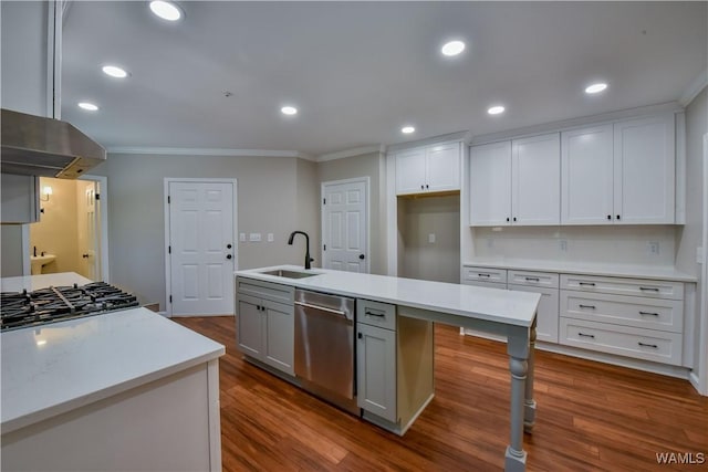 kitchen with dark wood finished floors, light countertops, recessed lighting, stainless steel dishwasher, and a sink