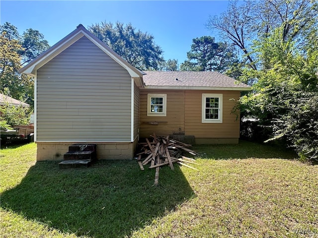 back of property with a lawn