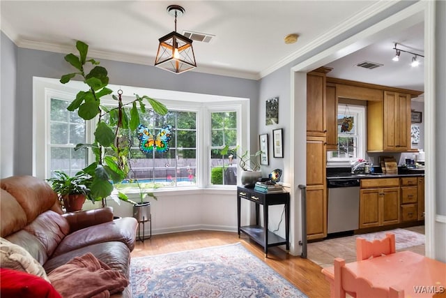1416 30th Ave E, Tuscaloosa, AL 35404 - kitchen featuring dishwasher, brown cabinets, open floor plan, light wood-style floors, and dark countertops