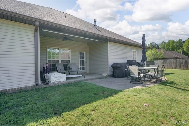 back of property featuring fence, a patio area, a lawn, a shingled roof, and ceiling fan