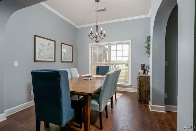dining area featuring baseboards, visible vents, a chandelier, and crown molding