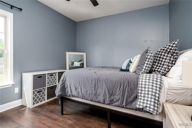 bedroom featuring wood finished floors, baseboards, and ceiling fan