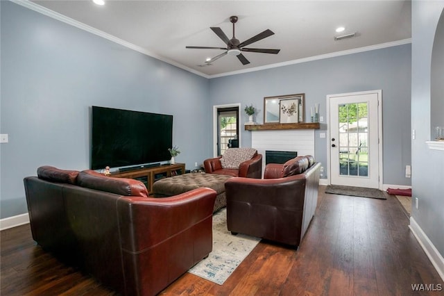 living room with a ceiling fan, plenty of natural light, a fireplace, baseboards, and visible vents