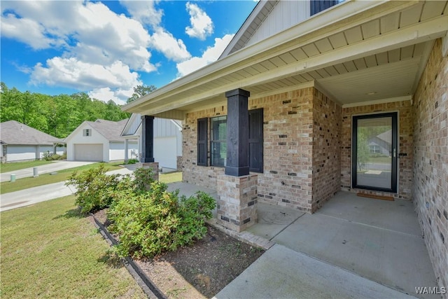 13024 Brookview Way, Northport, AL 35473 - view of exterior entry with board and batten siding, brick siding, a porch, and a lawn