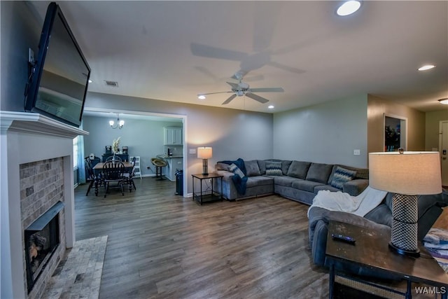 13024 Brookview Way, Northport, AL 35473 - living area featuring visible vents, wood finished floors, a fireplace, recessed lighting, and ceiling fan with notable chandelier