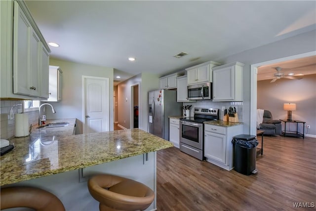 13024 Brookview Way, Northport, AL 35473 - kitchen with a sink, backsplash, stainless steel appliances, and dark wood-style floors