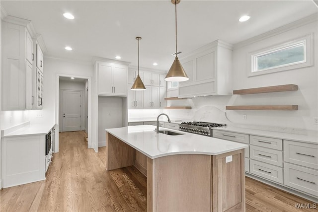 13952 Watercolor Pointe, Northport, AL 35475 - kitchen with visible vents, a center island with sink, a sink, light countertops, and ornamental molding