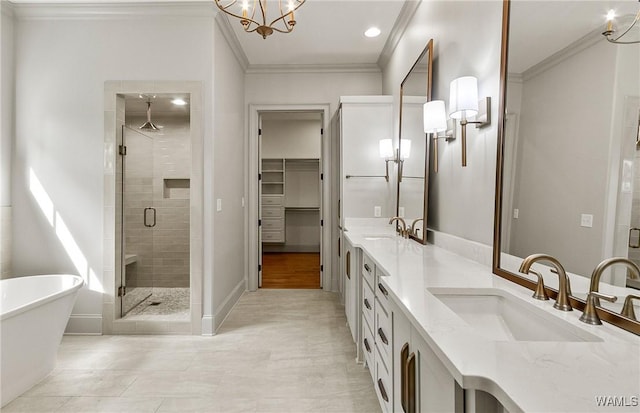 13952 Watercolor Pointe, Northport, AL 35475 - bathroom with crown molding, double vanity, a freestanding bath, a sink, and a stall shower