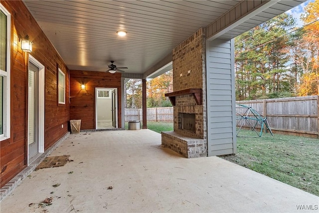 11480 Saint Joseph St, Northport, AL 35475 - fenced backyard featuring an outdoor brick fireplace, a patio area, and ceiling fan