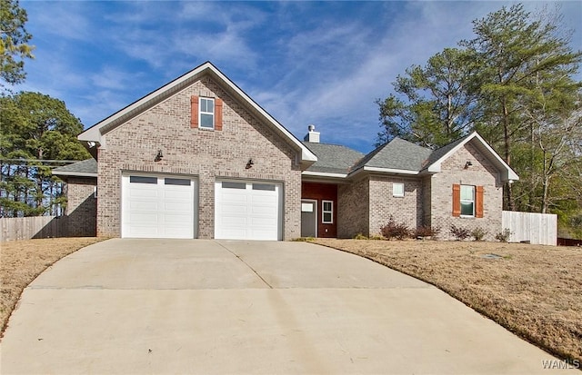 view of front of property featuring brick siding, concrete driveway, a chimney, and fence