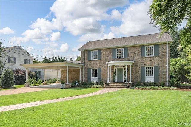 colonial home with a carport and a front yard