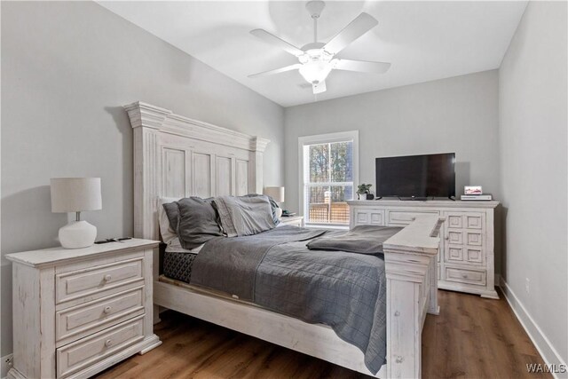 bedroom featuring dark wood-style floors, baseboards, and a ceiling fan