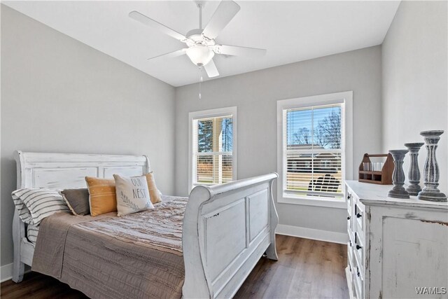 bedroom featuring ceiling fan, baseboards, and dark wood-type flooring