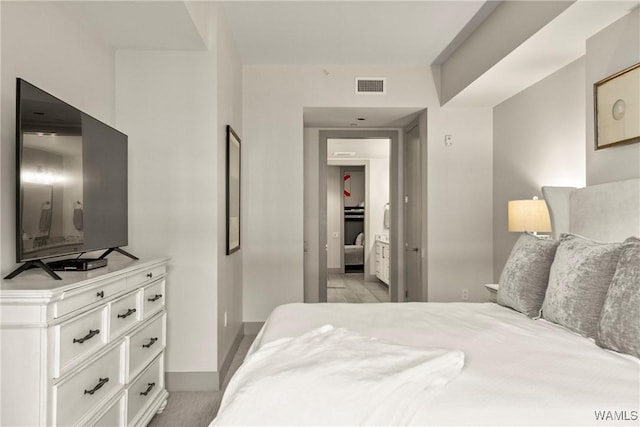 bedroom with visible vents and baseboards