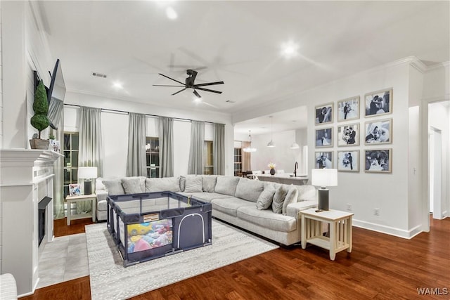 13862 Willow View Ln, Northport, AL 35475 - living area featuring ceiling fan, ornamental molding, recessed lighting, a fireplace with flush hearth, and wood finished floors