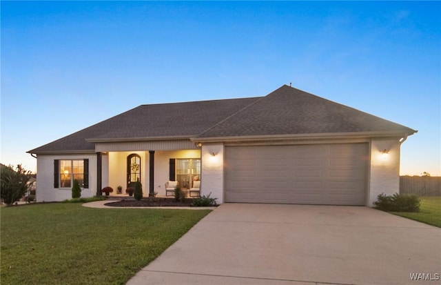 13862 Willow View Ln, Northport, AL 35475 - view of front of house featuring driveway, a garage, a lawn, and stucco siding