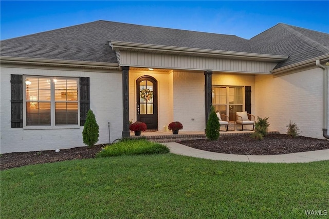 13862 Willow View Ln, Northport, AL 35475 - entrance to property featuring roof with shingles, brick siding, a yard, and a porch