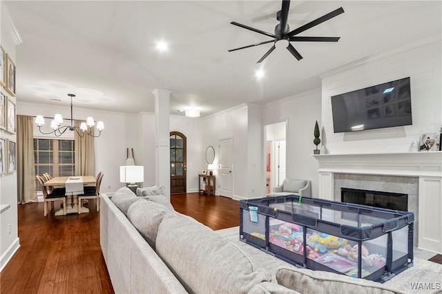 13862 Willow View Ln, Northport, AL 35475 - living room with a fireplace, dark wood finished floors, crown molding, a chandelier, and ceiling fan