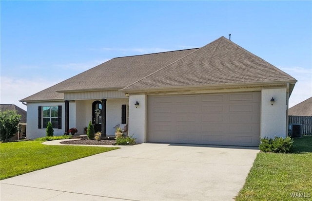 13862 Willow View Ln, Northport, AL 35475 - view of front facade with a shingled roof, a front yard, driveway, and a garage