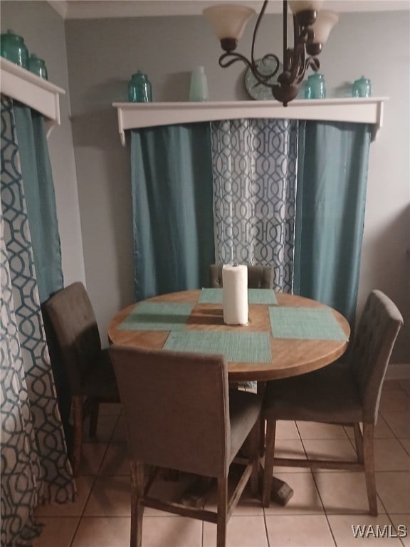 dining room with light tile patterned flooring and a chandelier