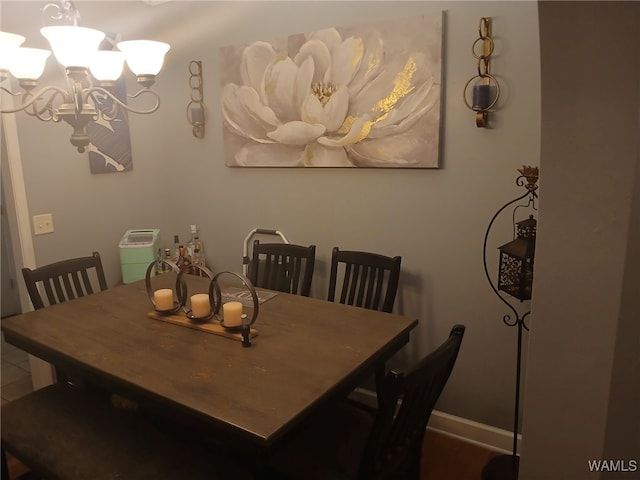 dining area with an inviting chandelier