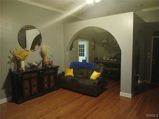 living room with dark hardwood / wood-style flooring and ornamental molding