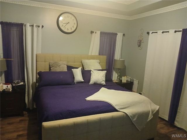 bedroom with dark hardwood / wood-style flooring and crown molding