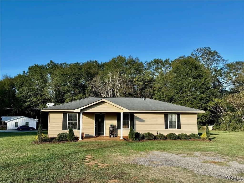 ranch-style home with a front lawn