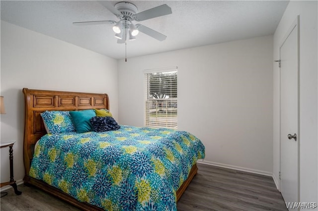 bedroom with ceiling fan and dark hardwood / wood-style floors