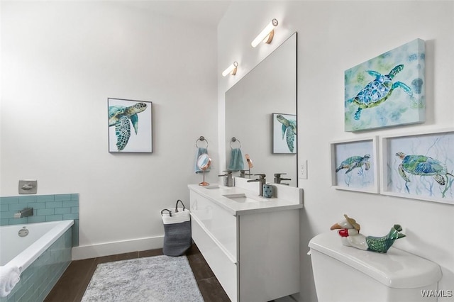 1038 14th Ave Unit B, Tuscaloosa, AL 35401 - full bathroom with toilet, double vanity, a bath, and baseboards