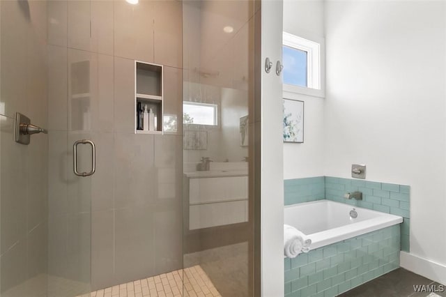 1038 14th Ave Unit B, Tuscaloosa, AL 35401 - bathroom with a shower stall, a bath, and vanity