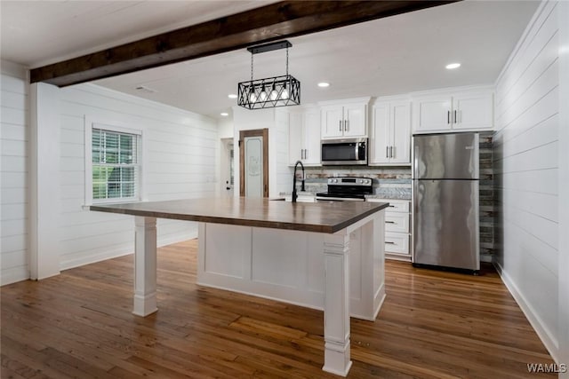 11376 Kings Loop Rd, Tuscaloosa, AL 35405 - kitchen featuring appliances with stainless steel finishes, a kitchen island with sink, beamed ceiling, white cabinetry, and dark wood finished floors