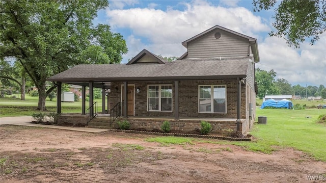 11376 Kings Loop Rd, Tuscaloosa, AL 35405 - view of front of home with brick siding, a front lawn, a shingled roof, and a porch