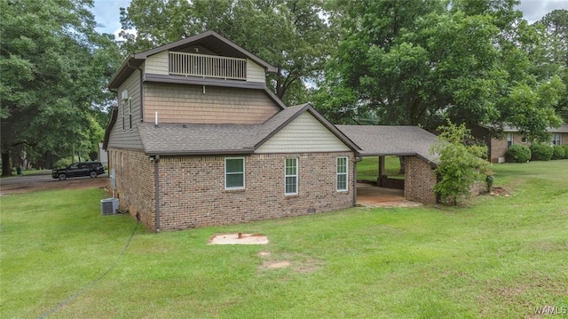 11376 Kings Loop Rd, Tuscaloosa, AL 35405 - view of side of home featuring brick siding, a lawn, a shingled roof, and a carport