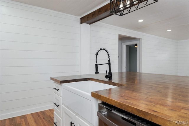 11376 Kings Loop Rd, Tuscaloosa, AL 35405 - kitchen with butcher block countertops, wood finished floors, white cabinets, stainless steel dishwasher, and recessed lighting