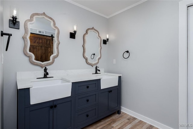 11376 Kings Loop Rd, Tuscaloosa, AL 35405 - bathroom featuring wood finished floors, double vanity, and ornamental molding